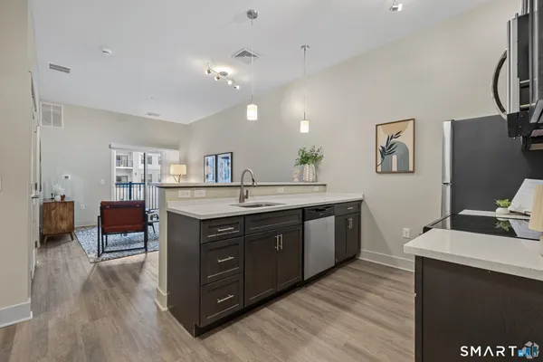 a kitchen with a sink and a refrigerator