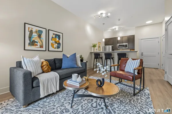 a living room with furniture and kitchen view