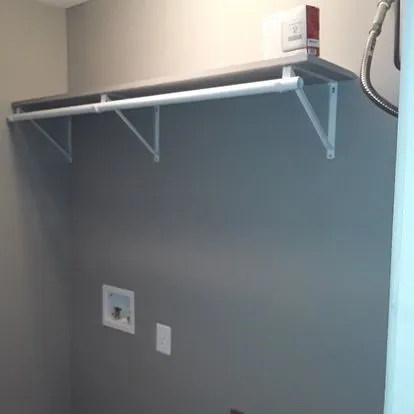 a view of a hallway with toilet and a window