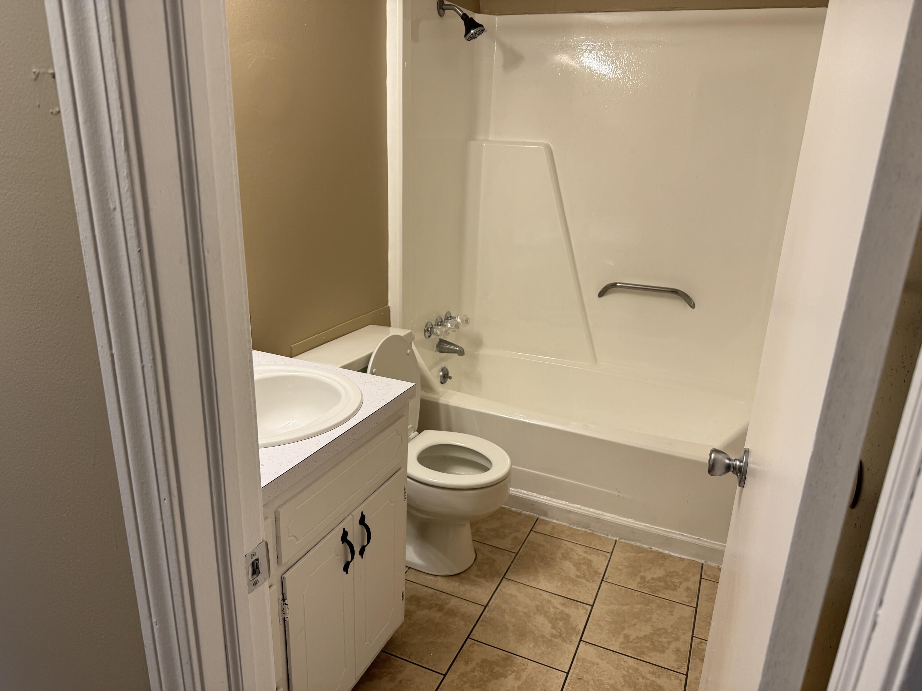 45 Vera Avenue, Unit 4 Collinsville, VA 24078 - Photo 6 of 8 a bathroom with a granite countertop sink toilet and shower