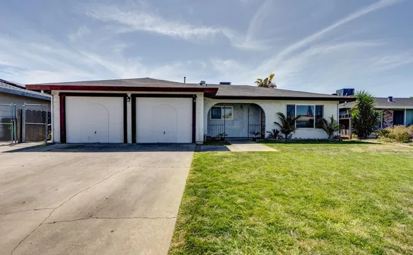 a house view with swimming pool in front of it