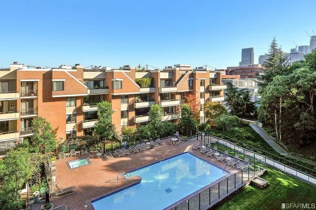 a view of a patio with swimming pool and sitting area