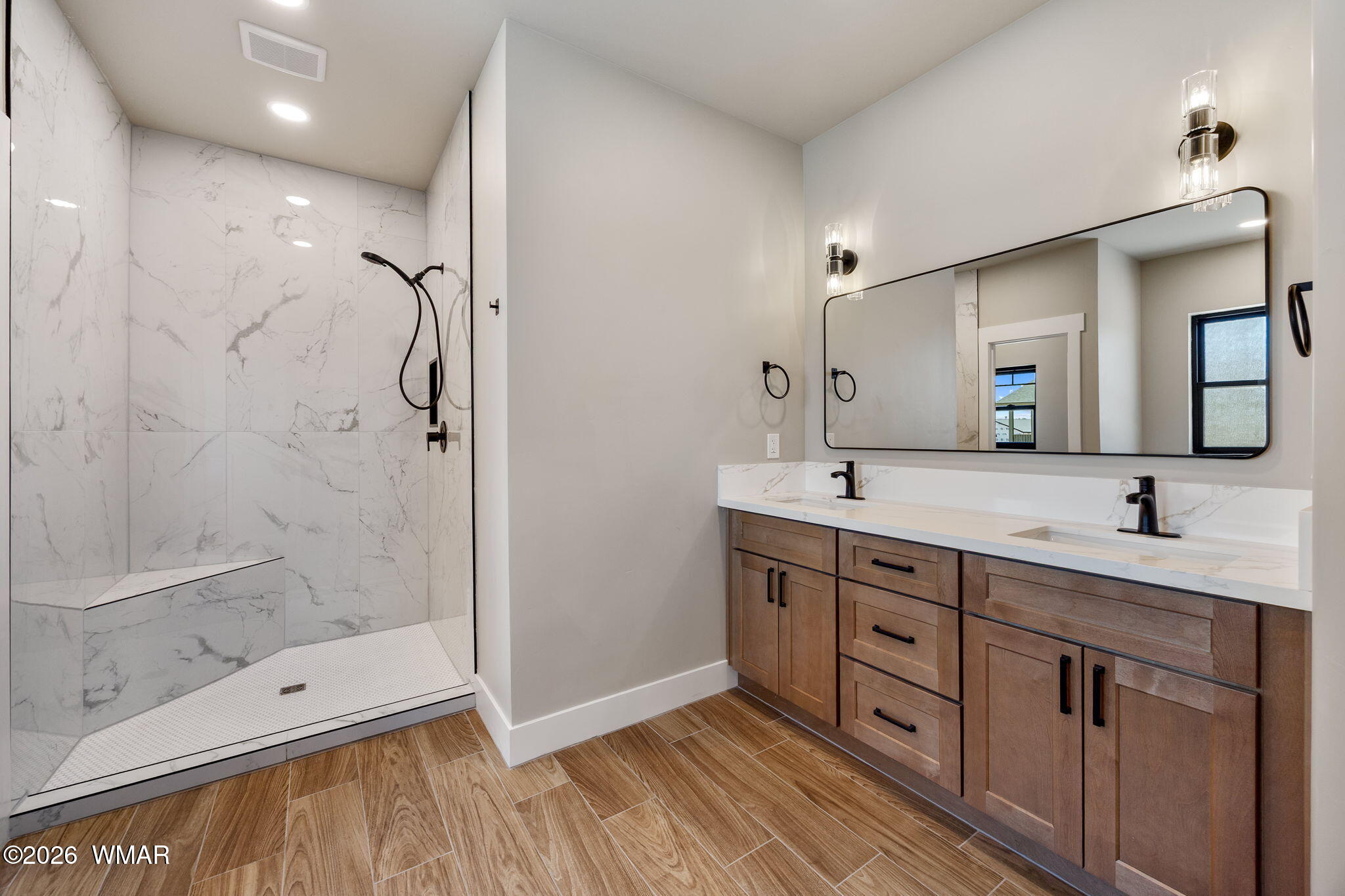 561 South Rock Ridge Drive Show Low, AZ 85901 - Photo 11 of 28 a bathroom with a double vanity sink mirror and shower