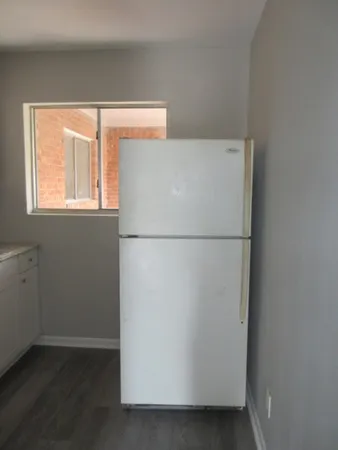 a white refrigerator freezer sitting in a kitchen