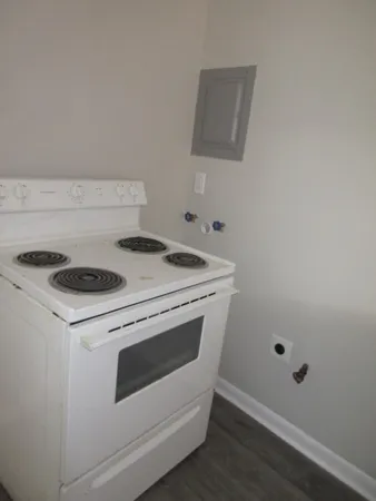 a stove top oven sitting inside of a kitchen