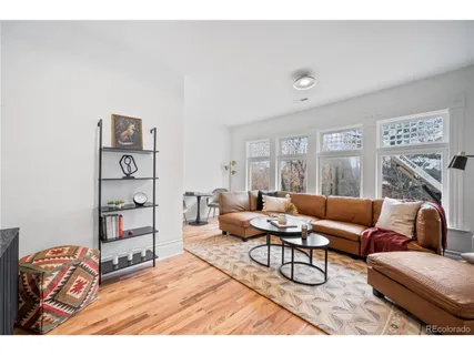 a living room with furniture a rug and white walls