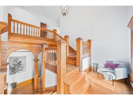 a living room with furniture a flat screen tv and a wall painting