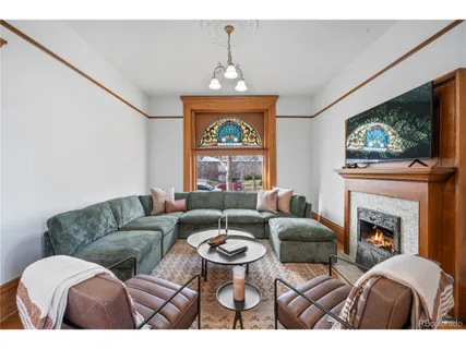 a living room with furniture a flat screen tv and a fireplace