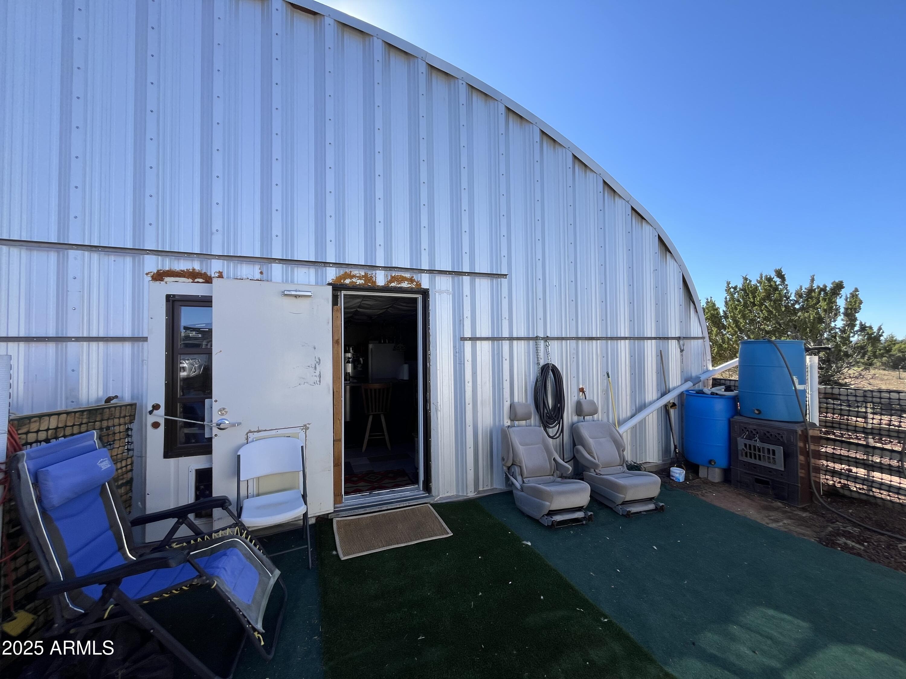 613 Mountain Cat Road, Unit 511 Williams, AZ 86046 - Photo 11 of 26 a view of a backyard with furniture and a grill