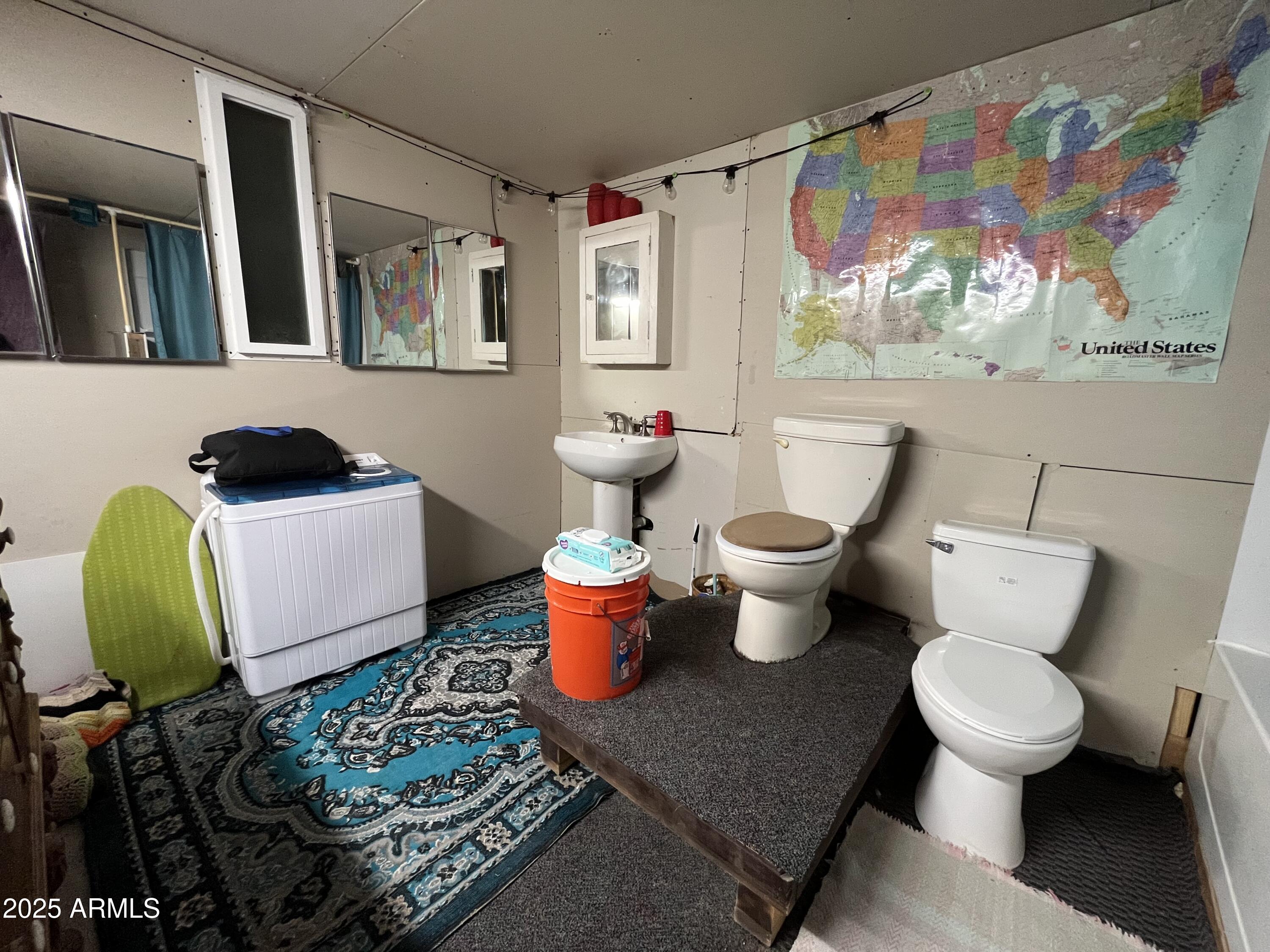 613 Mountain Cat Road, Unit 511 Williams, AZ 86046 - Photo 18 of 26 a bathroom with a toilet sink and mirror