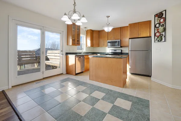 a kitchen with stainless steel appliances granite countertop a refrigerator and a sink