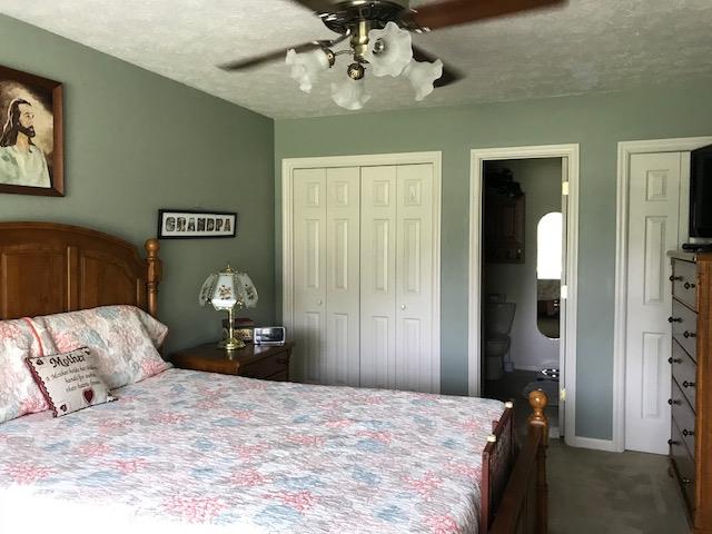 326 Denning Ford Road Portland, TN 37148 - Photo 15 of 28 a bedroom with a bed and a chandelier