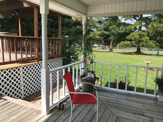 326 Denning Ford Road Portland, TN 37148 - Photo 3 of 28 a view of a balcony with chairs and wooden floor