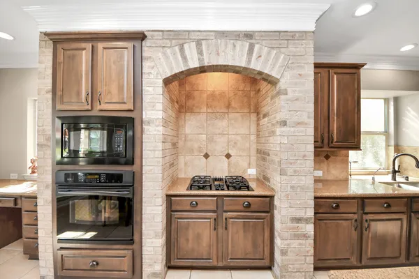 a kitchen with granite countertop a stove and a sink