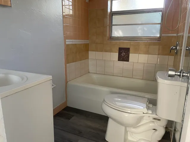 a white toilet sitting next to a bathroom sink