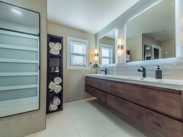 a bathroom with a toilet a sink and mirror