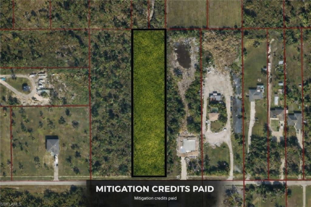 3247 54th Avenue Northeast Naples, FL 34120 - Photo 1 of 1 a sign that is on the side of a road