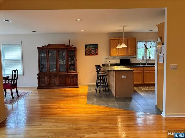 a kitchen with stainless steel appliances granite countertop a stove and a wooden floors