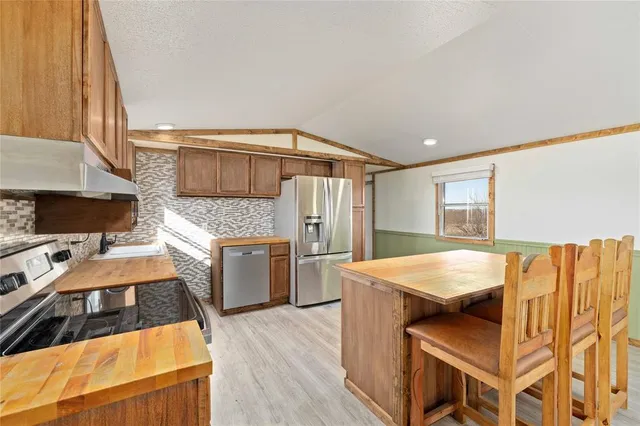 a kitchen that has a lot of cabinets in it and appliances