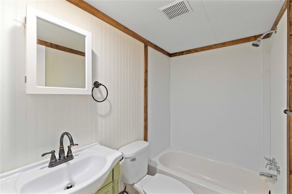 3393 Doe Trail Road Brownwood, TX 76801 - Photo 17 of 29 a bathroom with a sink toilet and shower