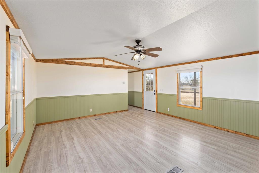 3393 Doe Trail Road Brownwood, TX 76801 - Photo 7 of 29 a view of room with window ceiling fan and hardwood floor