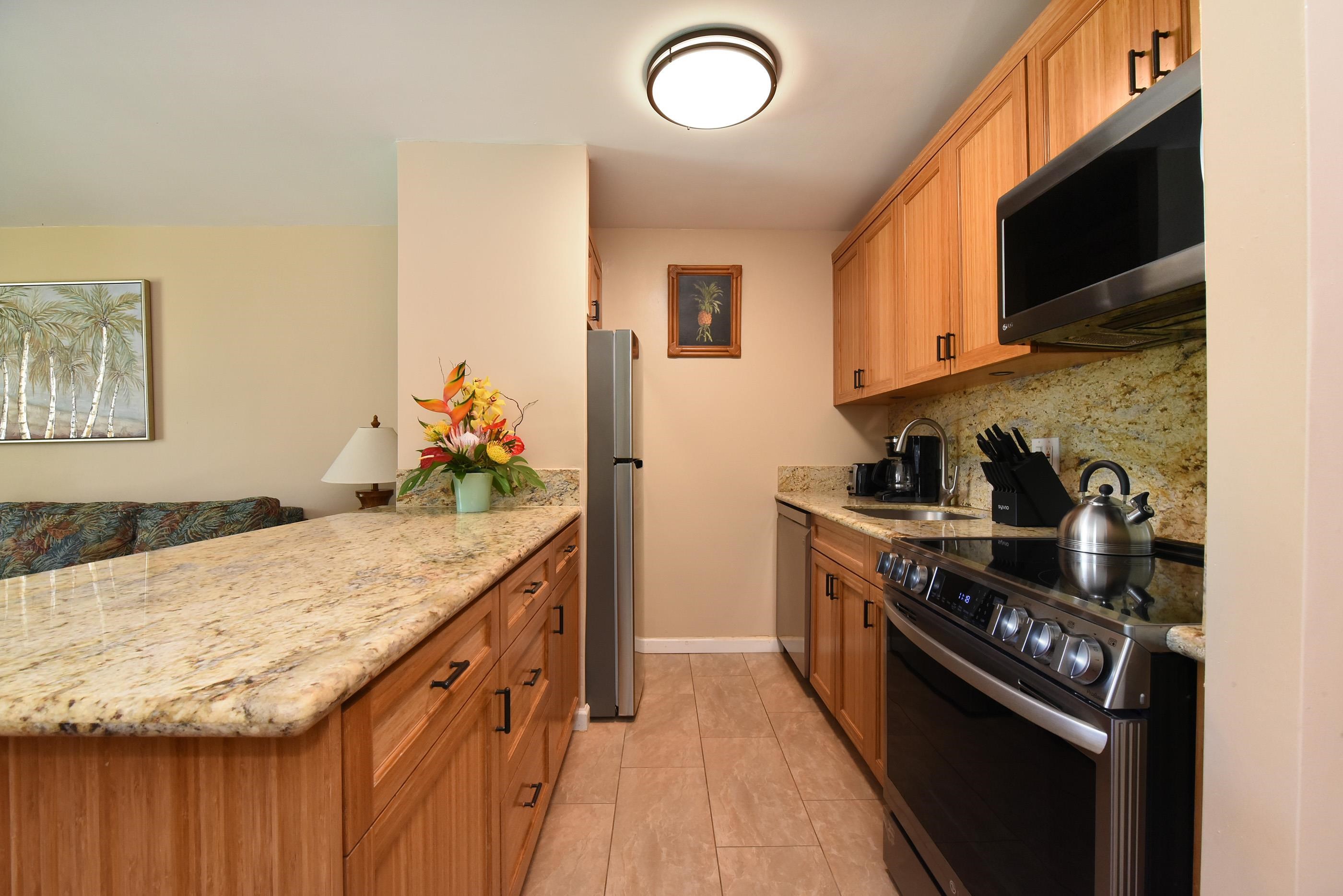 5315 Lower Honoapiilani Road, Unit F147 Lahaina, HI 96761 - Photo 15 of 41 a kitchen with granite countertop stainless steel appliances and sink