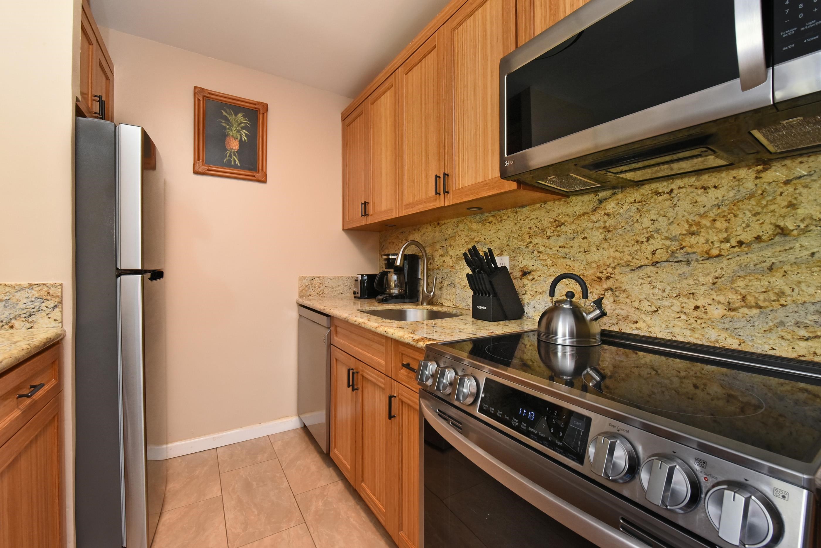 5315 Lower Honoapiilani Road, Unit F147 Lahaina, HI 96761 - Photo 16 of 41 a kitchen with a stove and a refrigerator