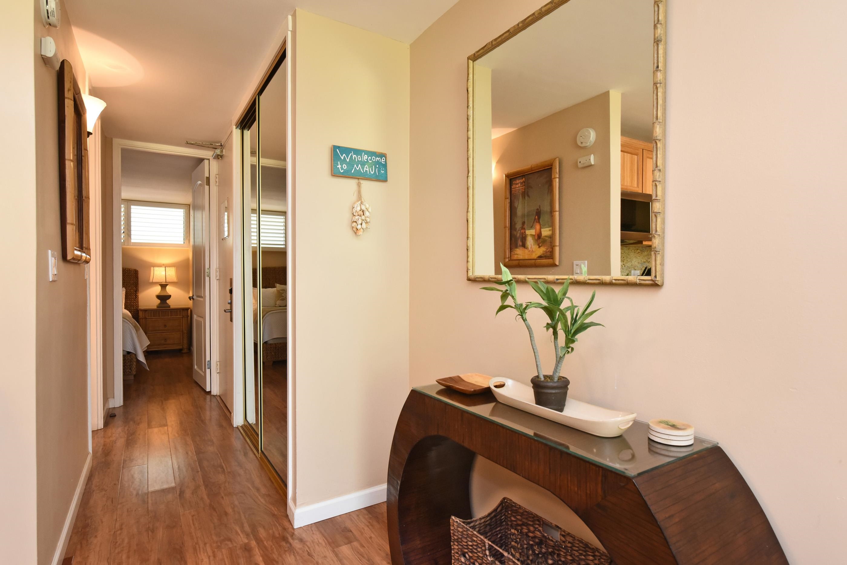 5315 Lower Honoapiilani Road, Unit F147 Lahaina, HI 96761 - Photo 17 of 41 a bedroom with a bed and wooden floor