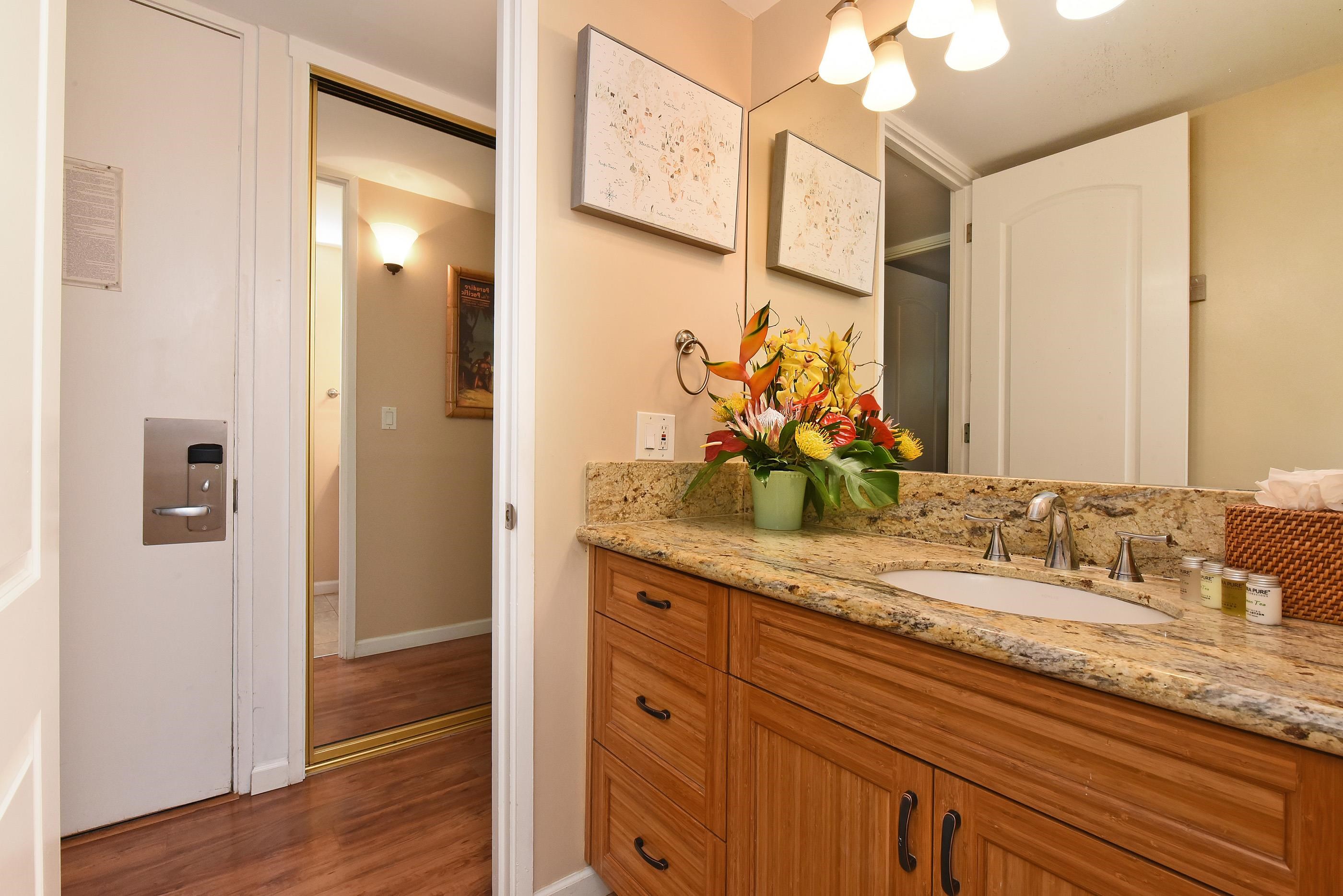 5315 Lower Honoapiilani Road, Unit F147 Lahaina, HI 96761 - Photo 20 of 41 a bathroom with a granite countertop double vanity sink and a mirror