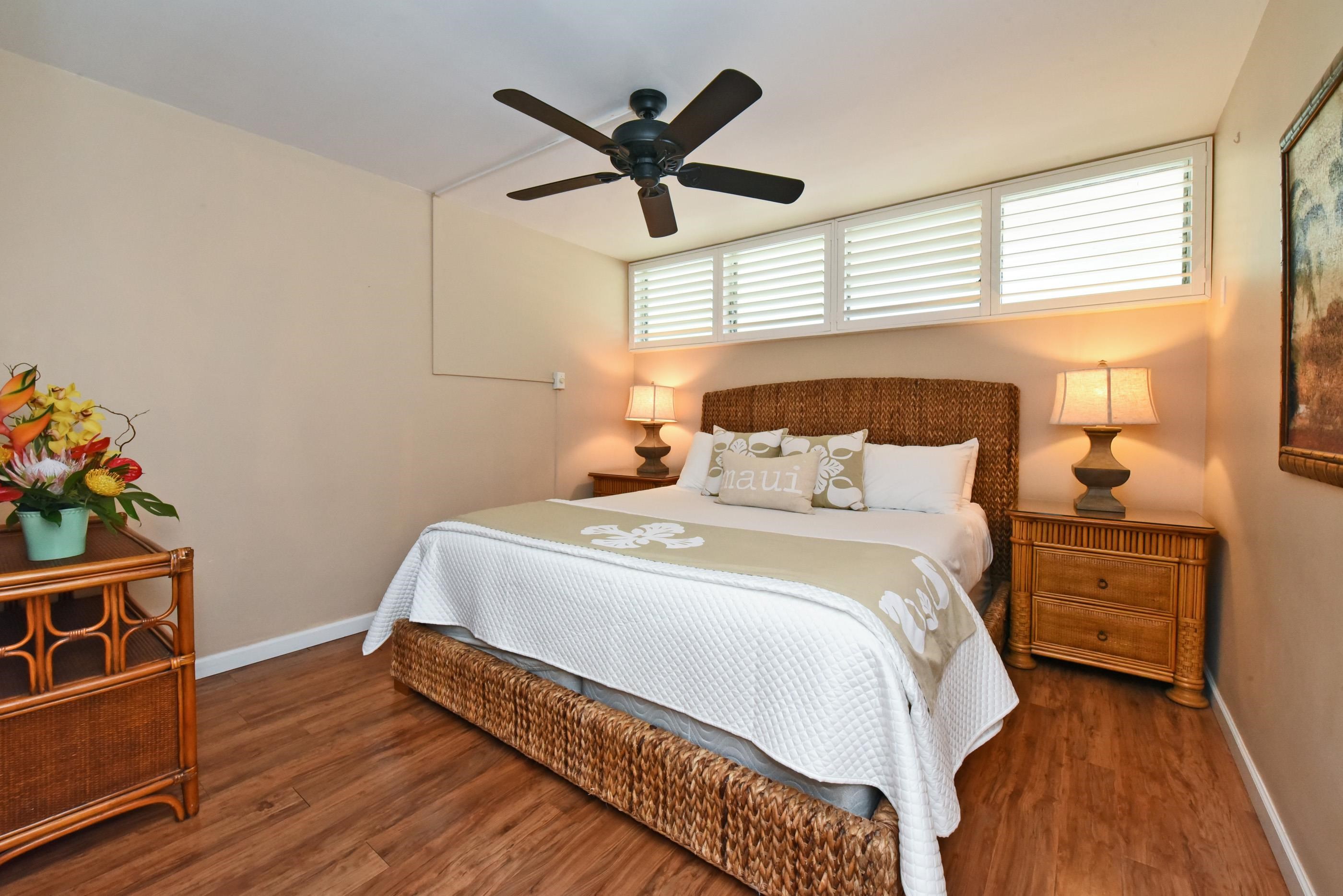 5315 Lower Honoapiilani Road, Unit F147 Lahaina, HI 96761 - Photo 22 of 41 a bedroom with a bed and wooden floor