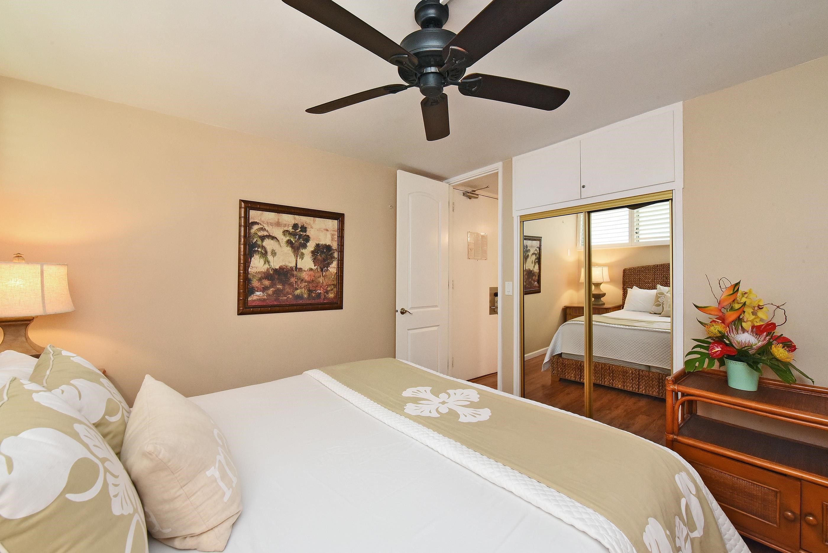 5315 Lower Honoapiilani Road, Unit F147 Lahaina, HI 96761 - Photo 25 of 41 a bedroom with a bed and a chandelier