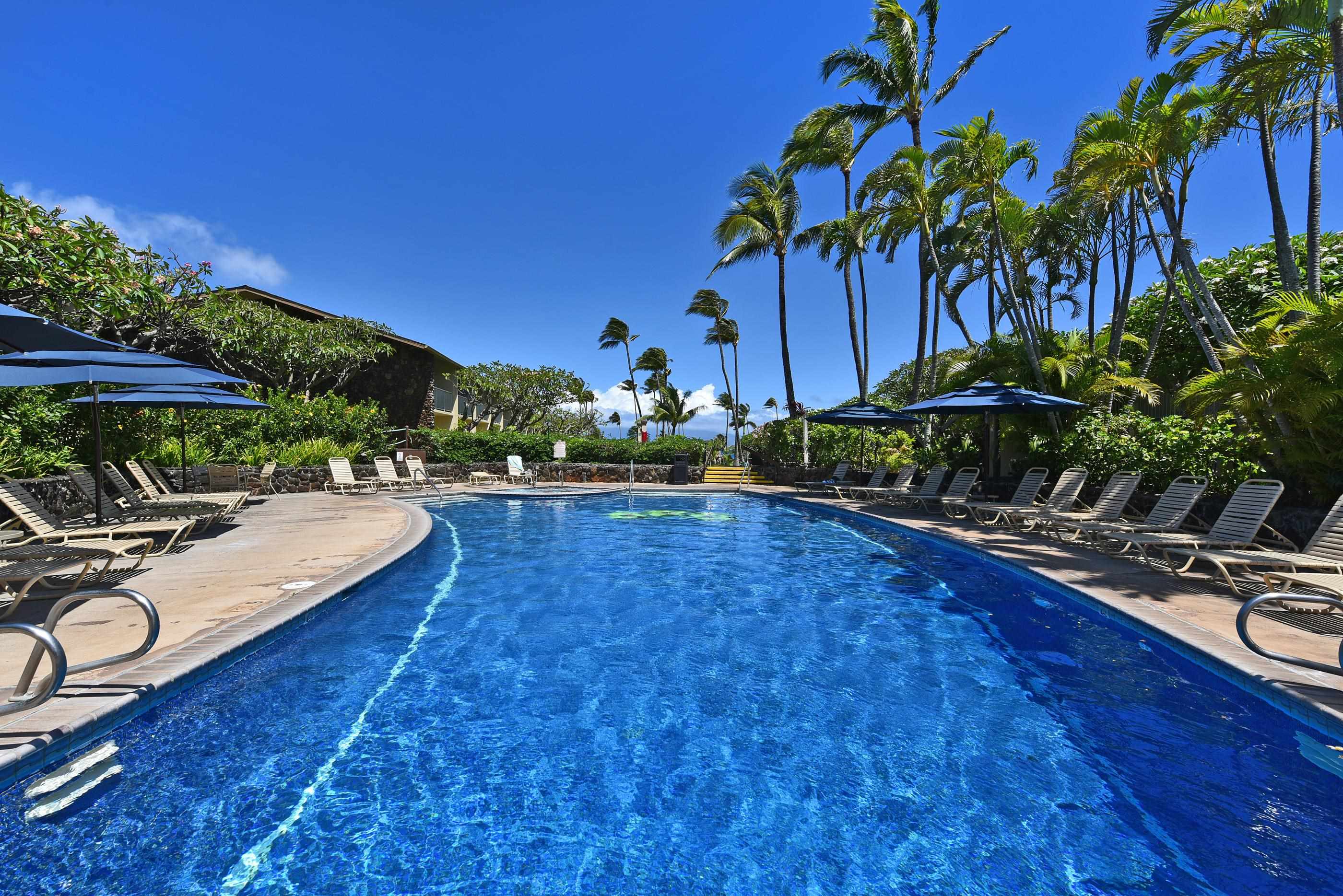 5315 Lower Honoapiilani Road, Unit F147 Lahaina, HI 96761 - Photo 29 of 41 a view of a swimming pool with a table and chairs under an umbrella