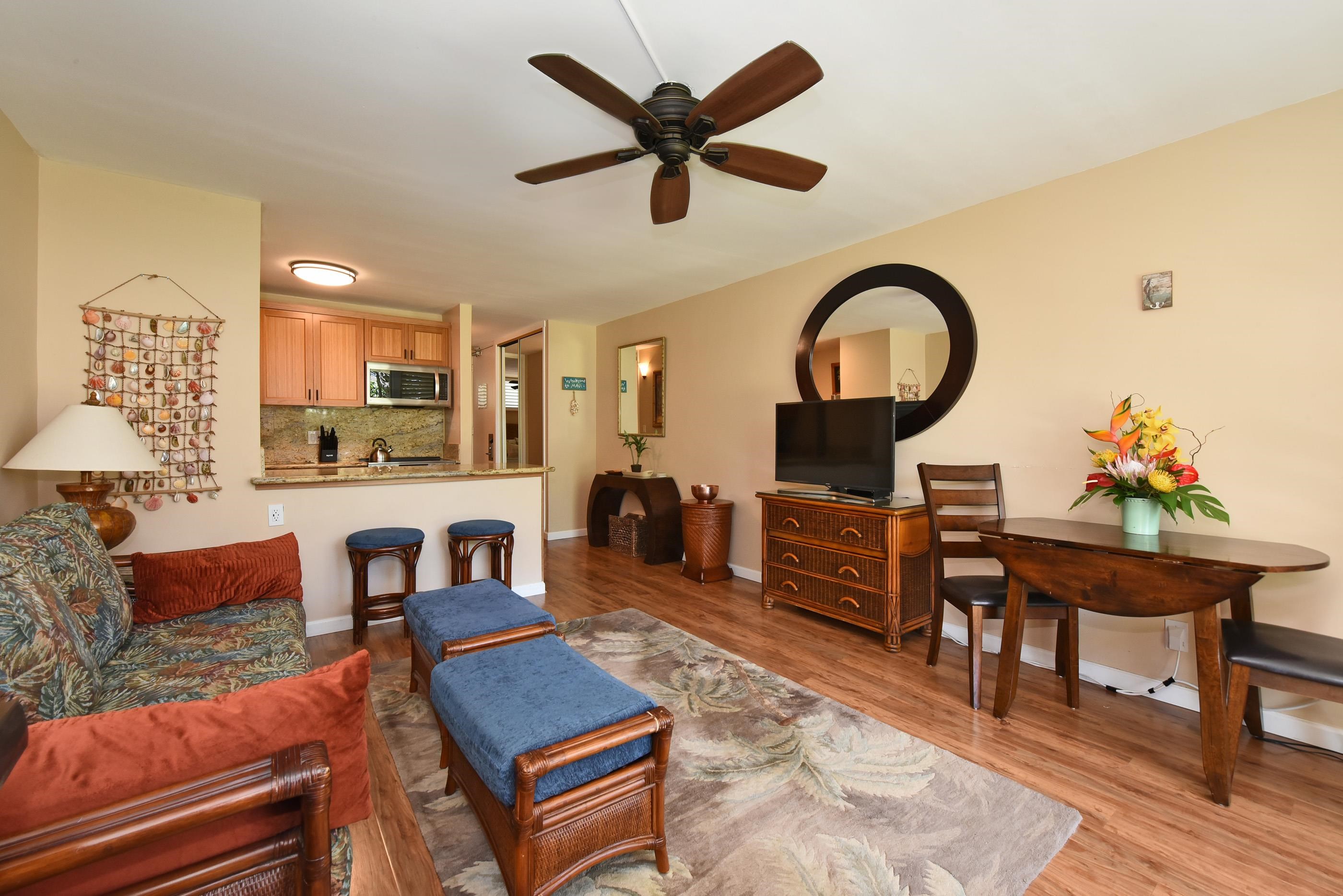 5315 Lower Honoapiilani Road, Unit F147 Lahaina, HI 96761 - Photo 6 of 41 a living room with furniture a rug and a fireplace