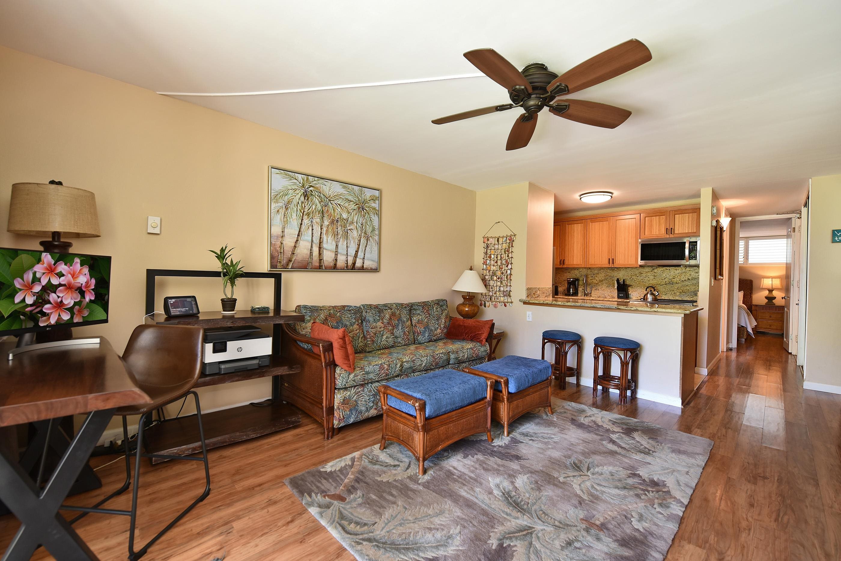 5315 Lower Honoapiilani Road, Unit F147 Lahaina, HI 96761 - Photo 7 of 41 a living room with furniture kitchen view and a wooden floor