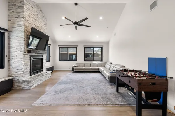 a living room with furniture a flat screen tv and a fireplace