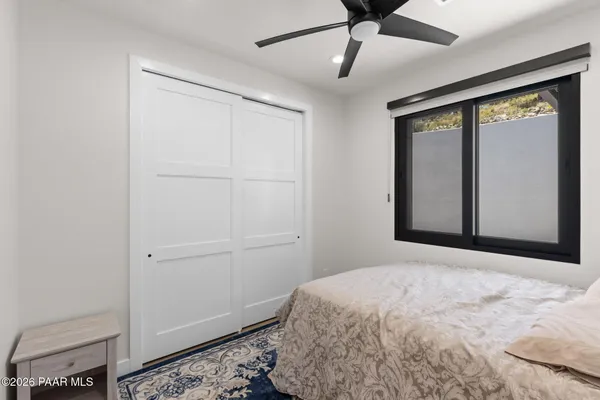 a bedroom with a bed and a window