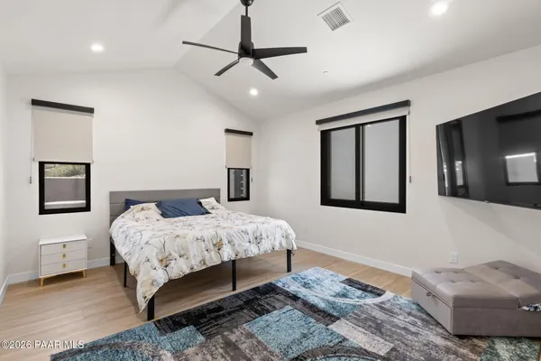 a bedroom with a large bed and a window