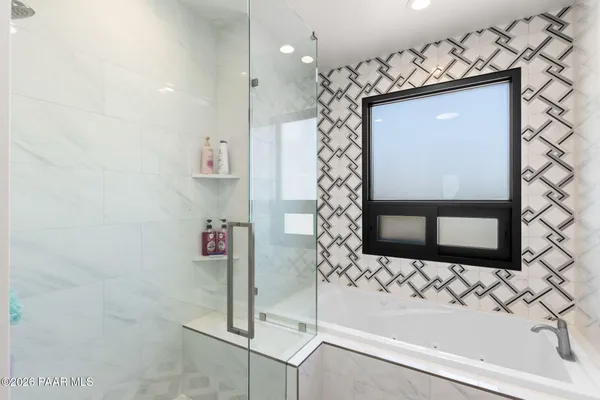 a bathroom with a shower and a sink