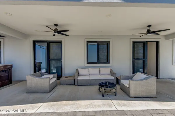 a living room with furniture and a ceiling fan