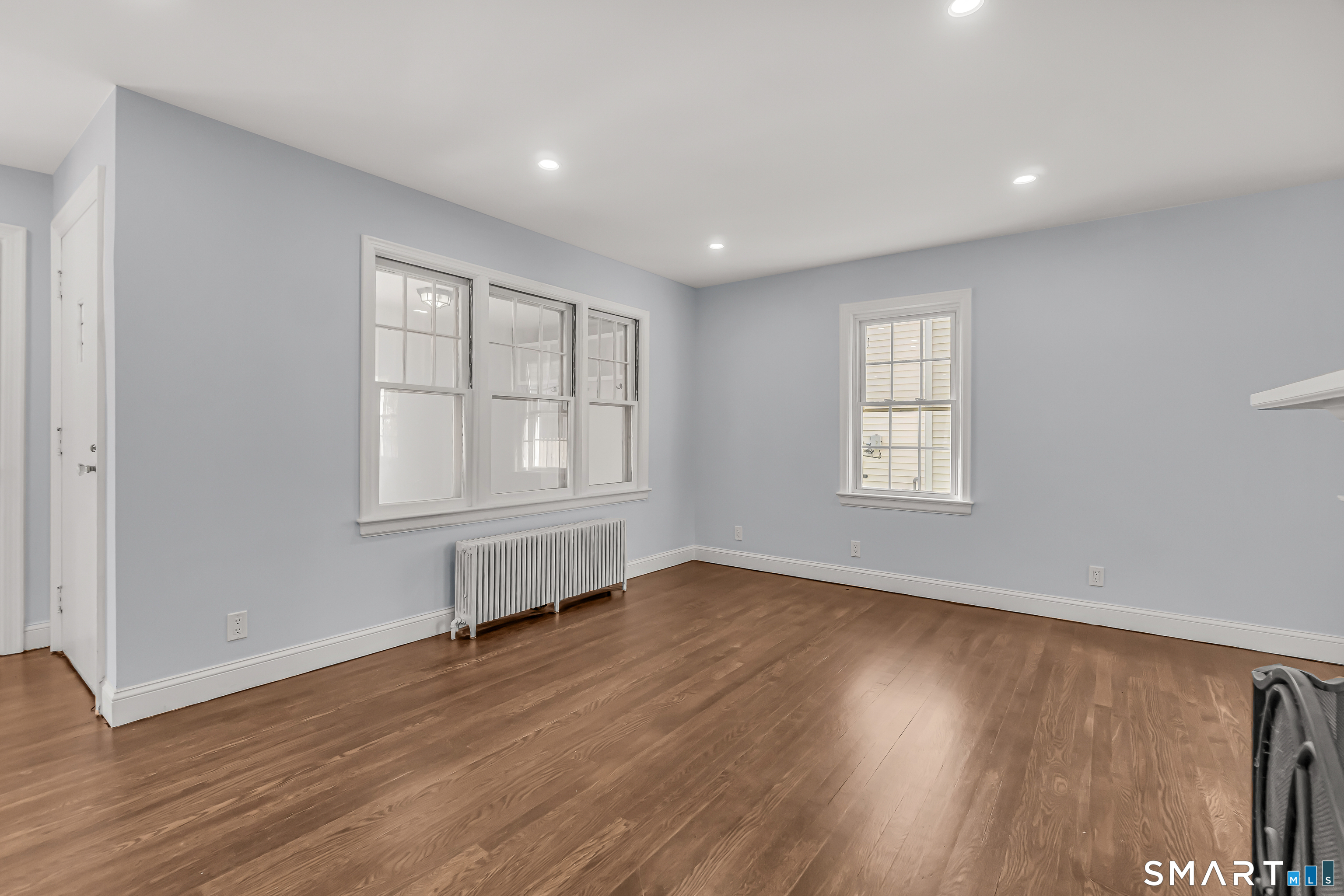 1770 Stratfield Road Fairfield, CT 06825 - Photo 9 of 40 an empty room with wooden floor and windows