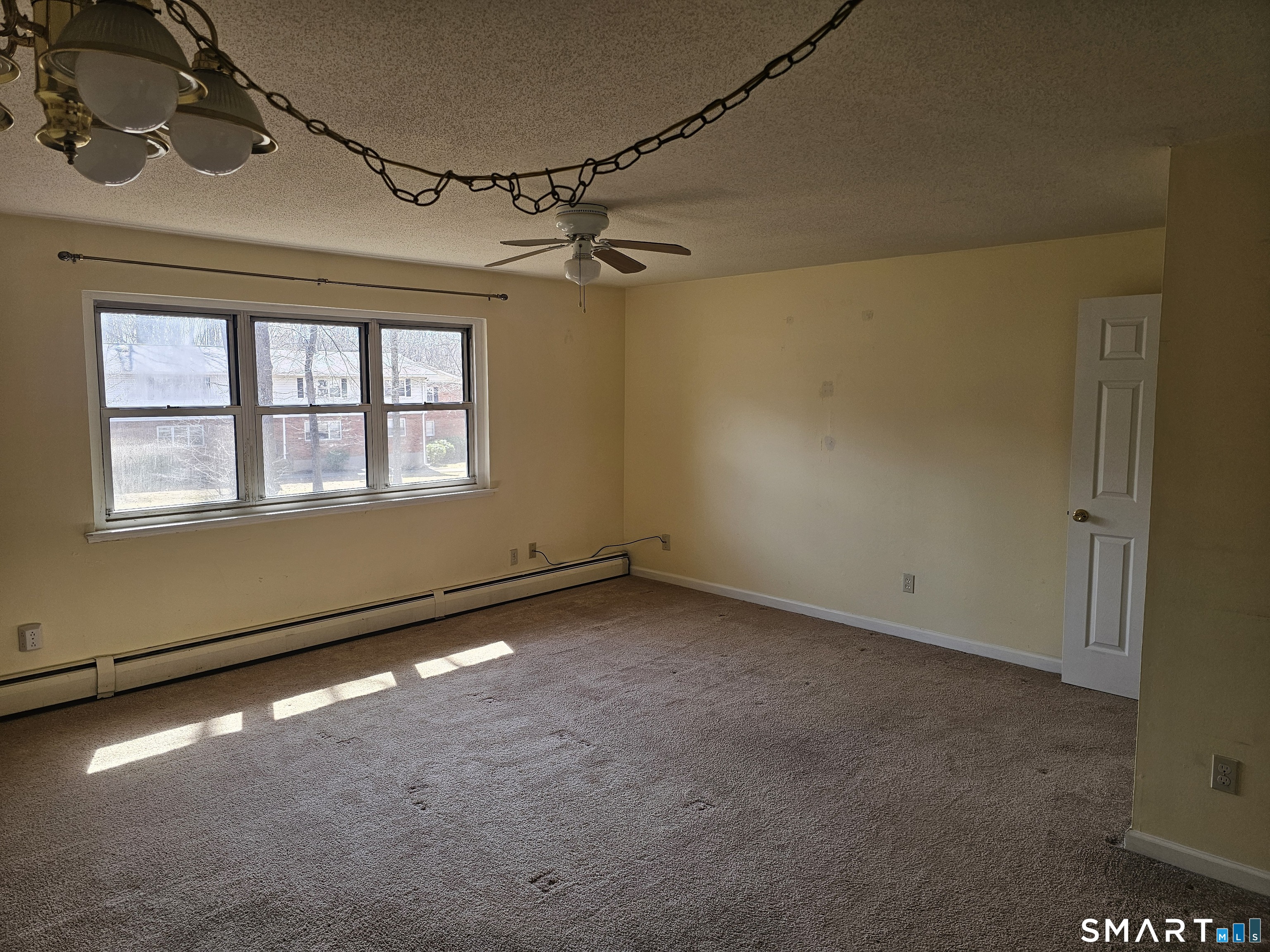 Undisclosed Address Cheshire, CT 06410 - Photo 2 of 12 an empty room with a empty space and windows