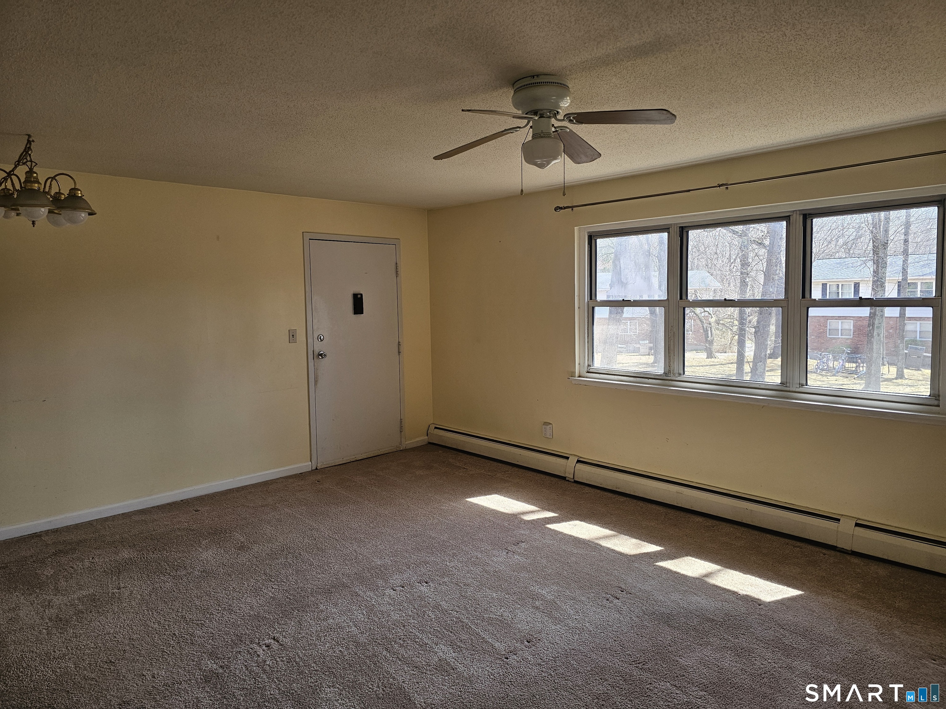 Undisclosed Address Cheshire, CT 06410 - Photo 3 of 12 a view of an empty room with a window