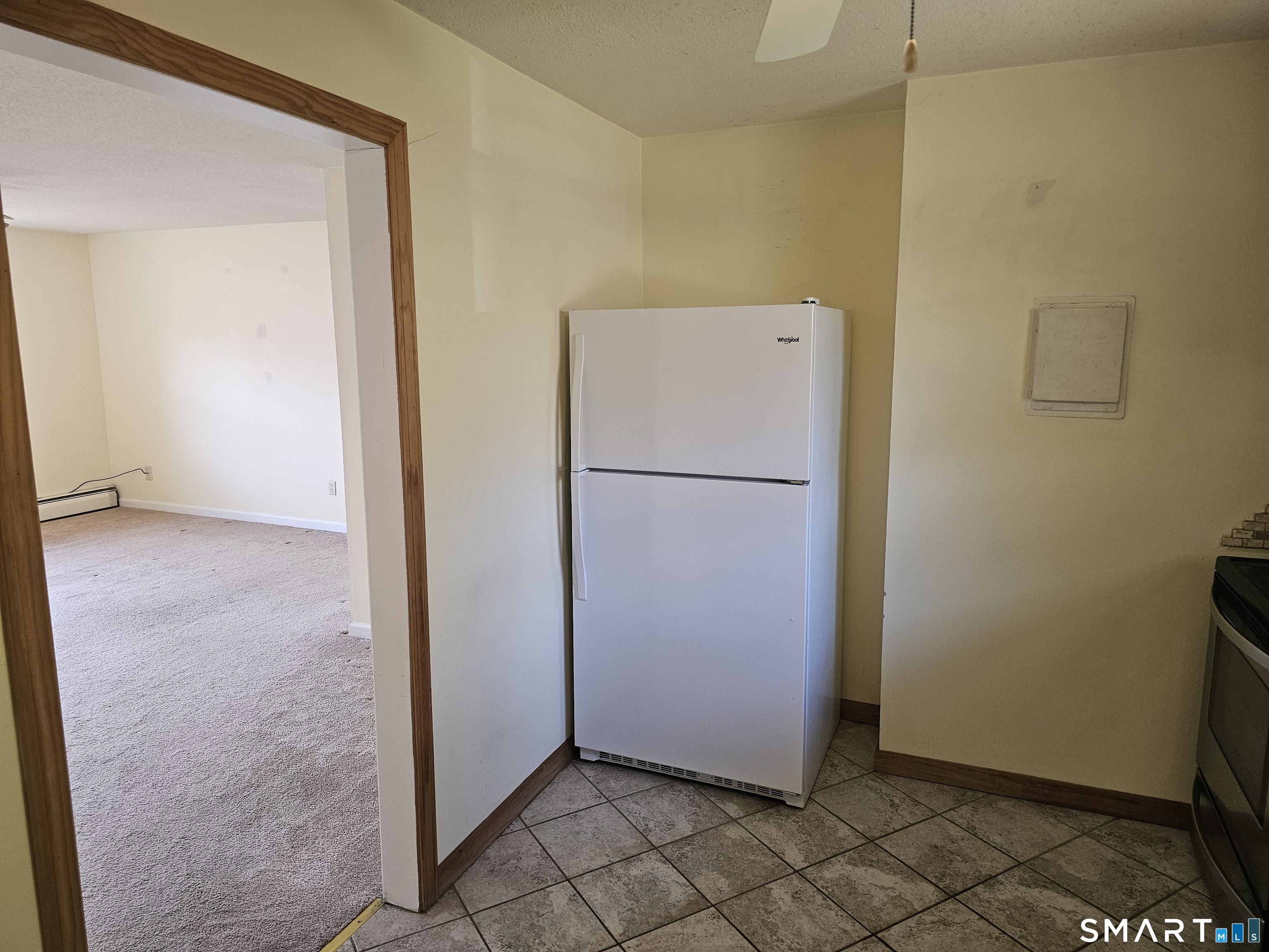 Undisclosed Address Cheshire, CT 06410 - Photo 7 of 12 a view of a refrigerator in kitchen and an empty room