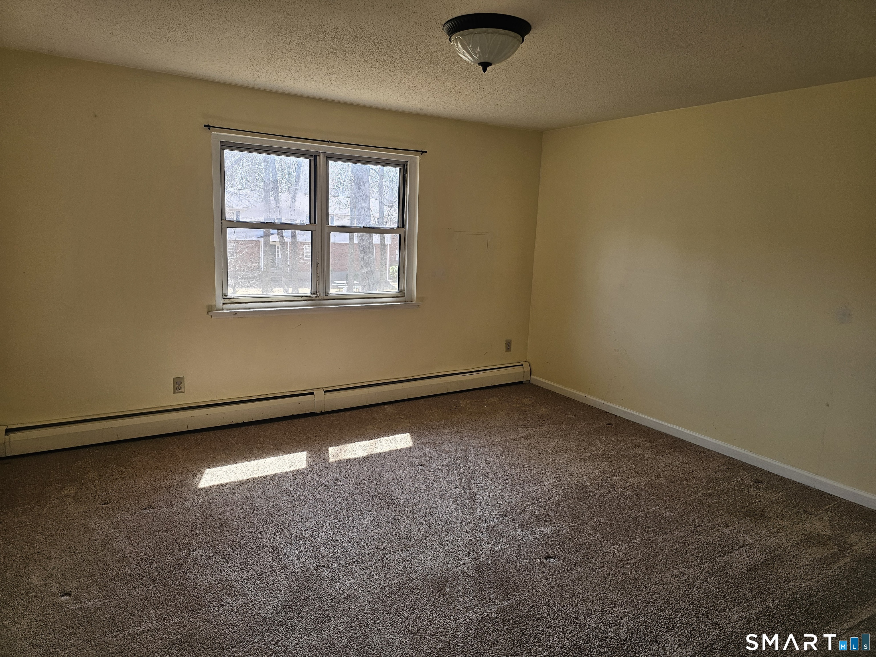 Undisclosed Address Cheshire, CT 06410 - Photo 9 of 12 an empty room with a empty space and a window