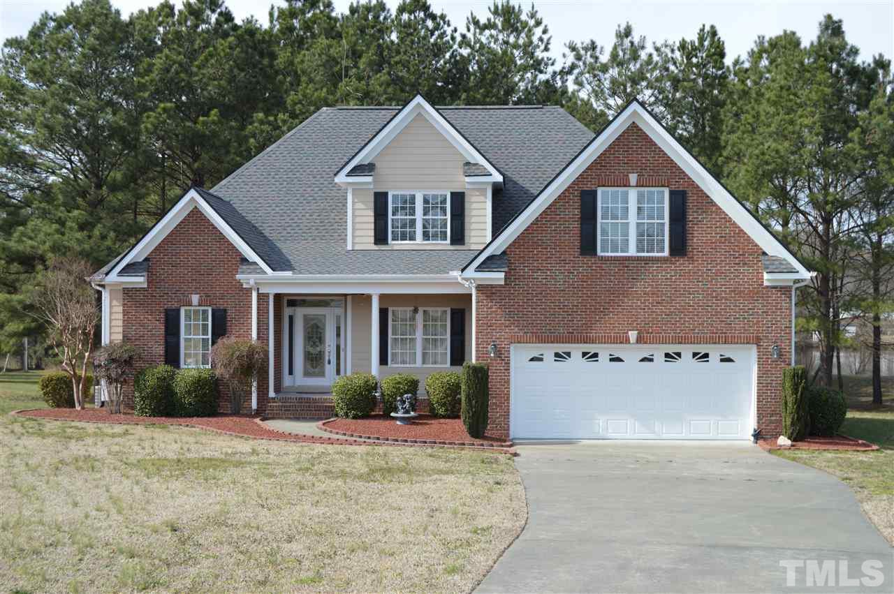 1069 Wheeler Pond Road Creedmoor, NC 27522 - Photo 1 of 22 a view of a yard in front of a house with plants and large tree