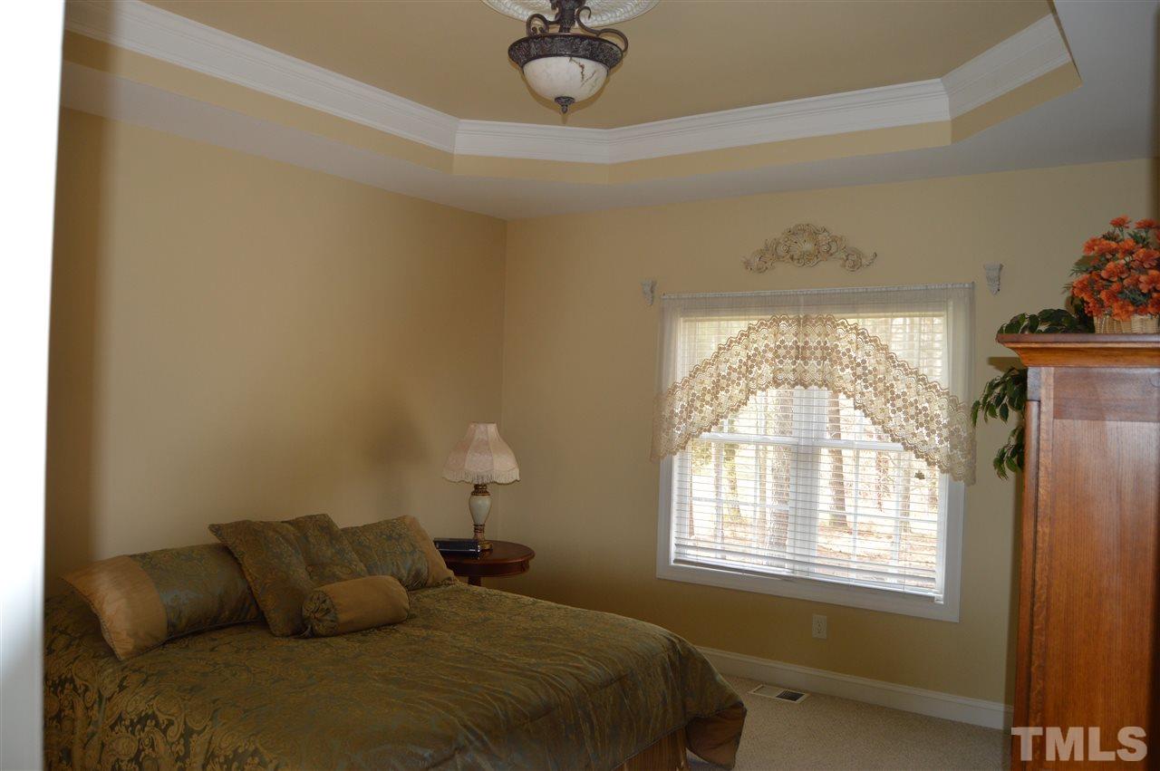1069 Wheeler Pond Road Creedmoor, NC 27522 - Photo 11 of 22 a bedroom with a bed and window