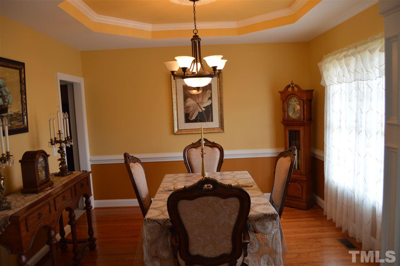 1069 Wheeler Pond Road Creedmoor, NC 27522 - Photo 2 of 22 a view of a dining room with furniture and wooden floor