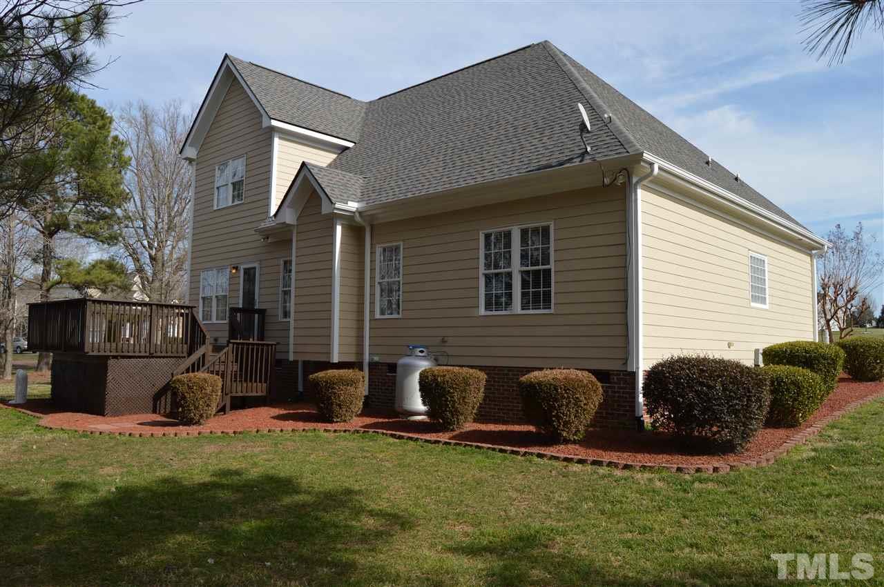 1069 Wheeler Pond Road Creedmoor, NC 27522 - Photo 21 of 22 a backyard of a house with table and chairs