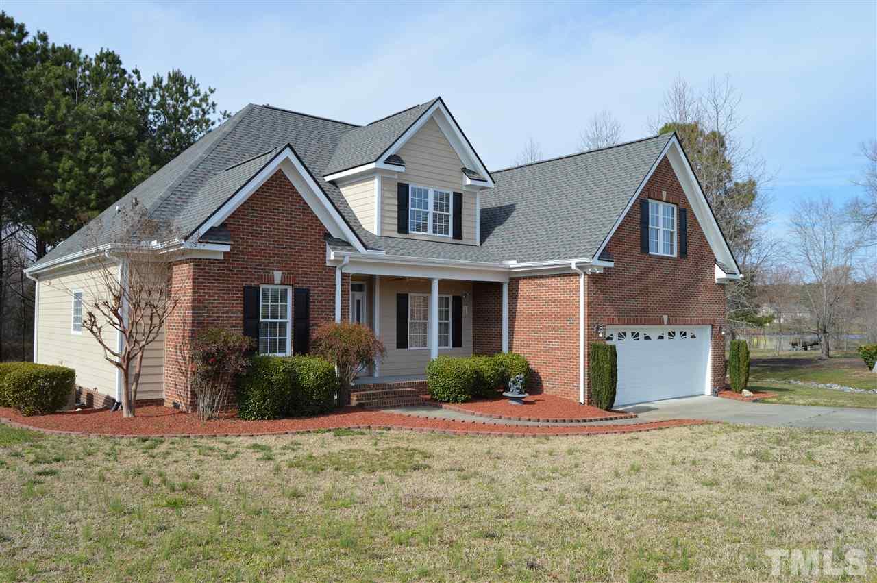 1069 Wheeler Pond Road Creedmoor, NC 27522 - Photo 22 of 22 a front view of a house with a yard and garage