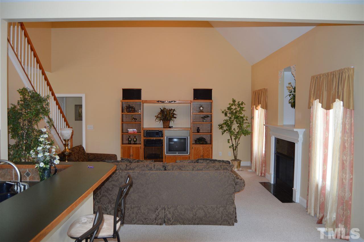 1069 Wheeler Pond Road Creedmoor, NC 27522 - Photo 5 of 22 a living room with furniture a fireplace and a flat screen tv